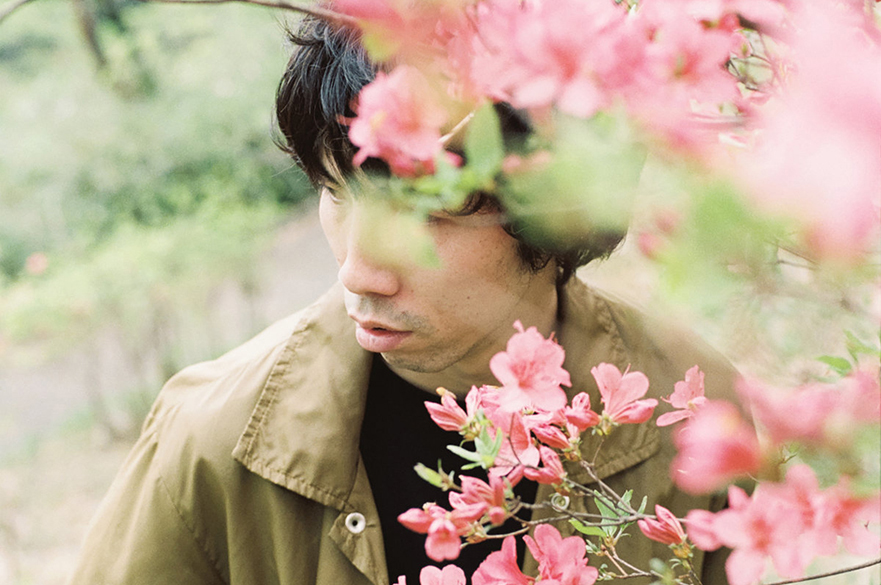 Anchorsong stood behind blossom branches.