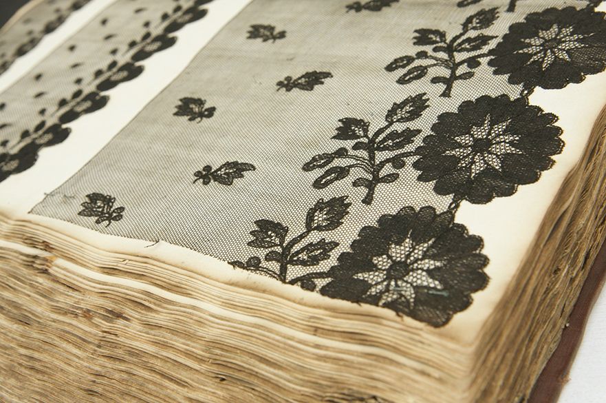 A book filled with various patterns of lace showcasing the lace produced in Nottingham's Lace Market.  