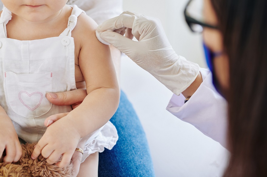 Baby with nurse after vaccination