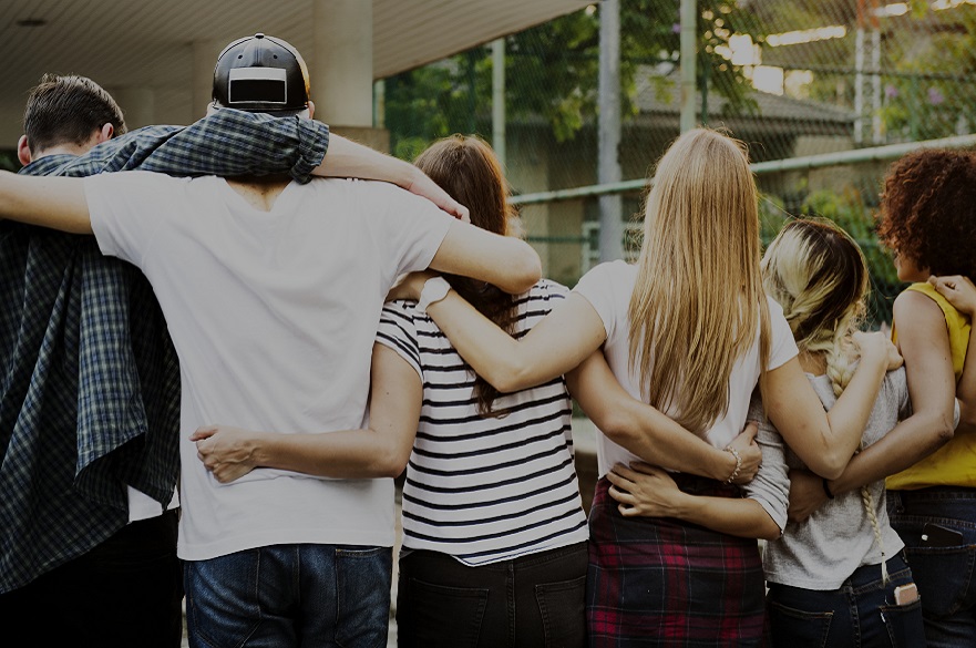 Group of people with arms around each other