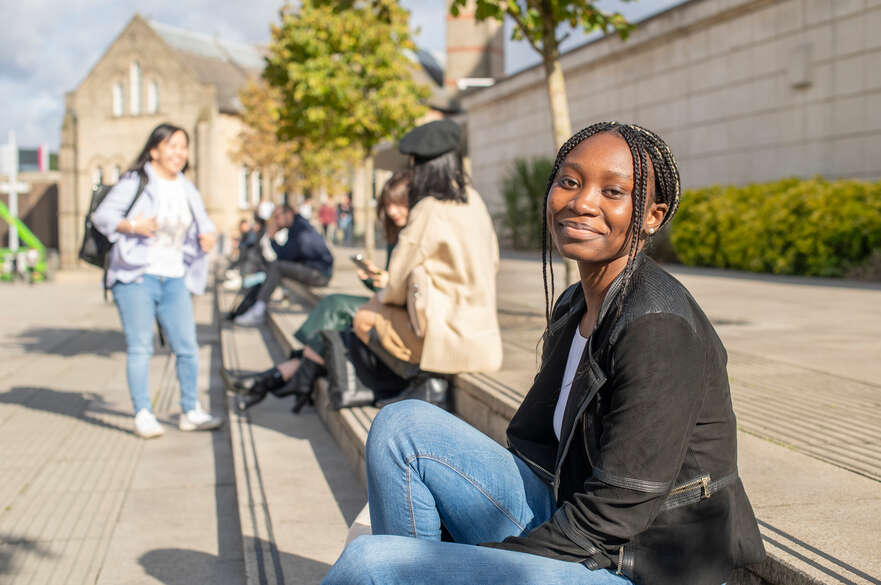 Student outside newton building