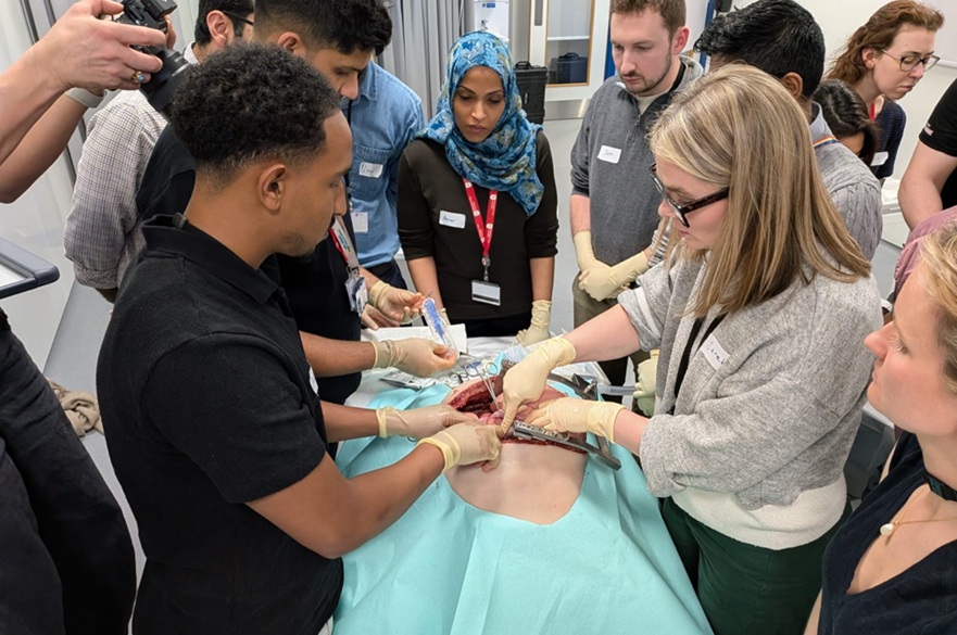 Surgeons performing an operation on a fake body