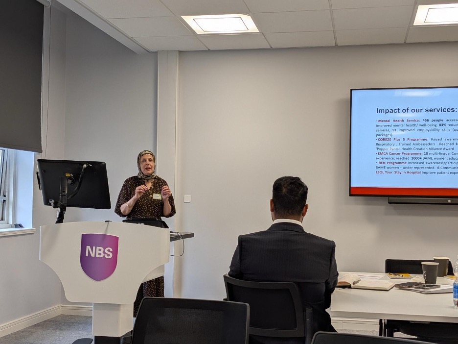   Khudeja Amer-Sharif, CEO of Shama Women's Centre, delivering the keynote address on understanding migration and AMR