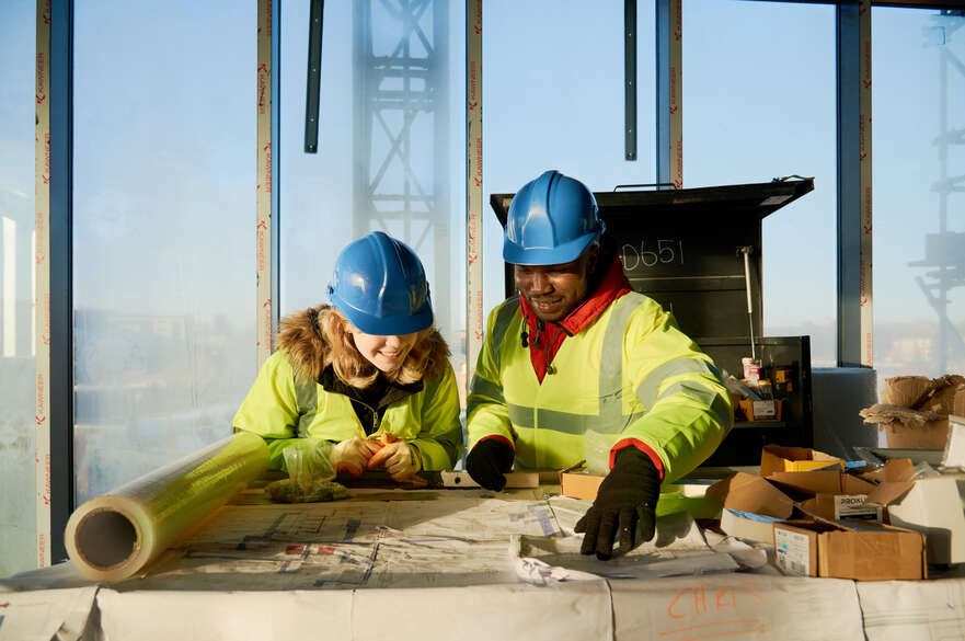 Two construction students looking at building plans