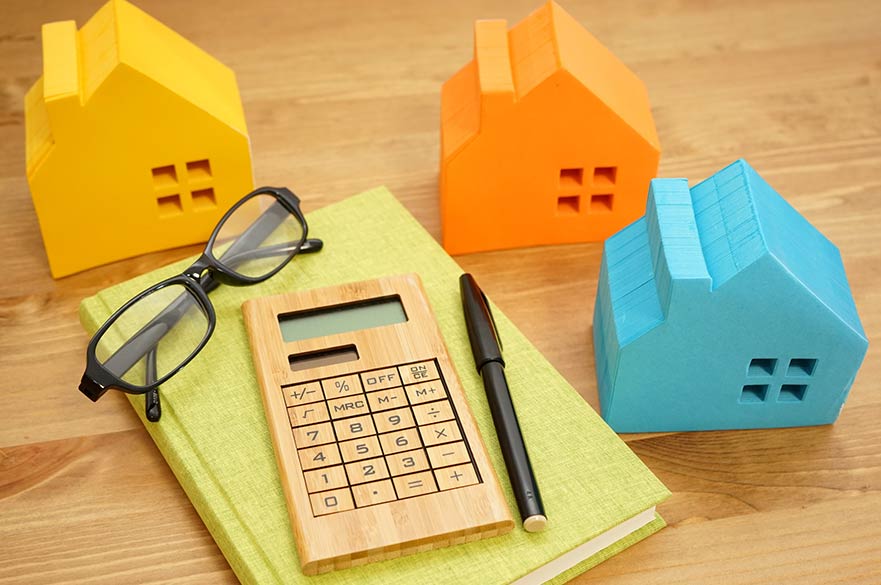 Calculator and model houses on desk