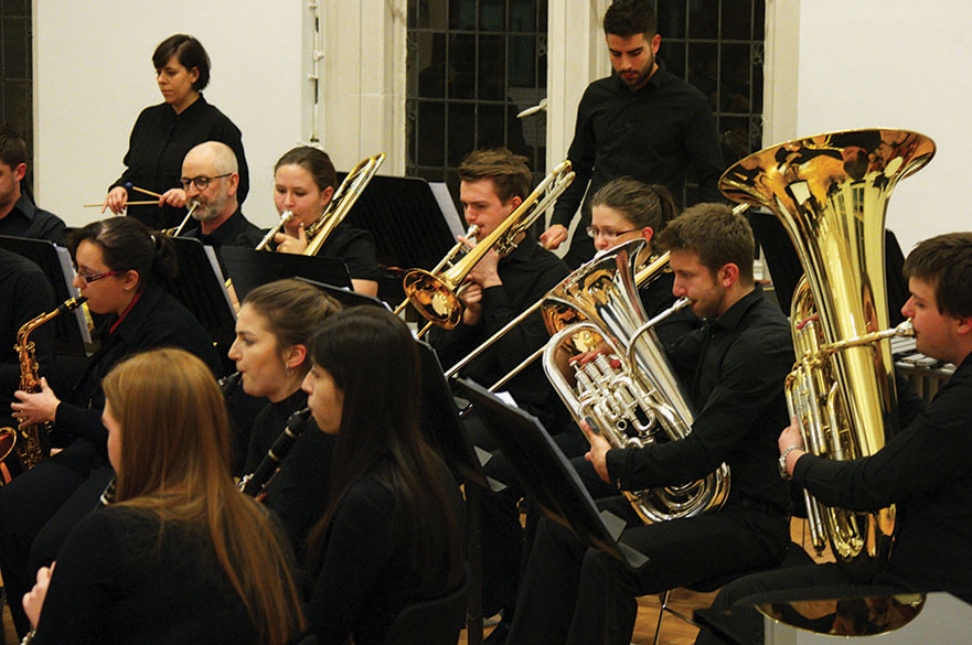 Male and female musicians playing brass instruments