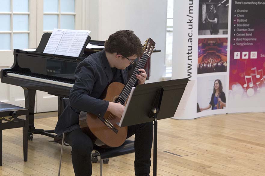 Male student playing guitar