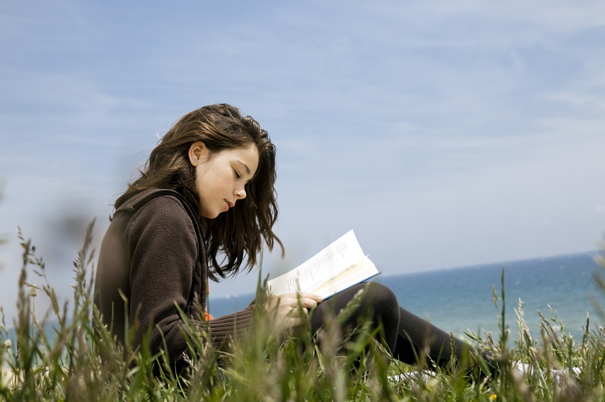 Young woman writing in a book