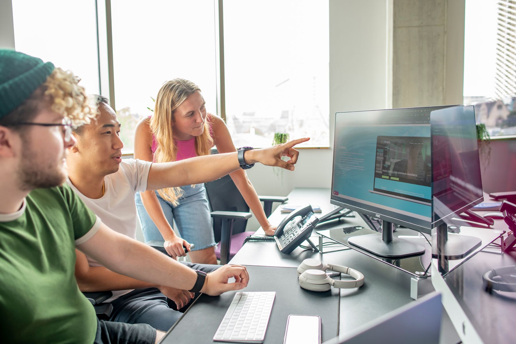 Three people looking at screen