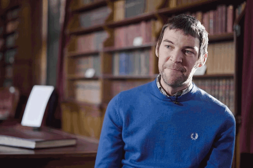 Simon Brown, History graduate sits in the library at Newstead Abbey