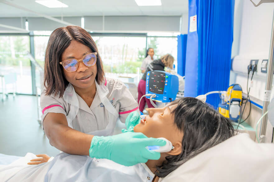 A student nurse working with a dummy in the HAP Centre