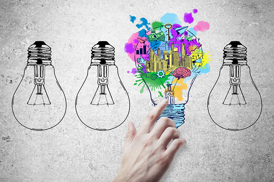 Concept image of four lightbulbs, one turned upwards with colourful graphics demonstrating entrepreneurship
