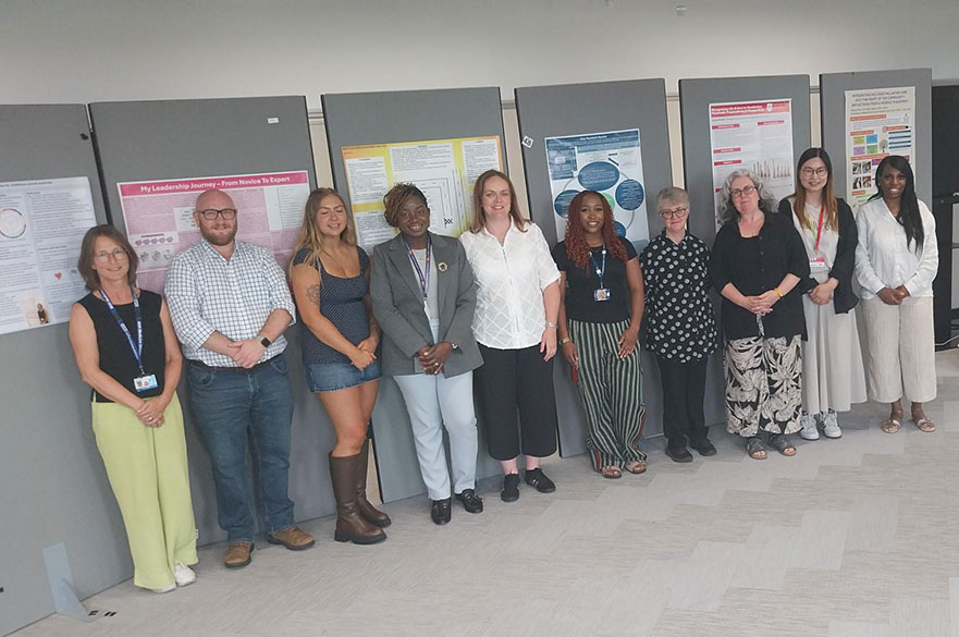 Group of students in front of their poster presentations