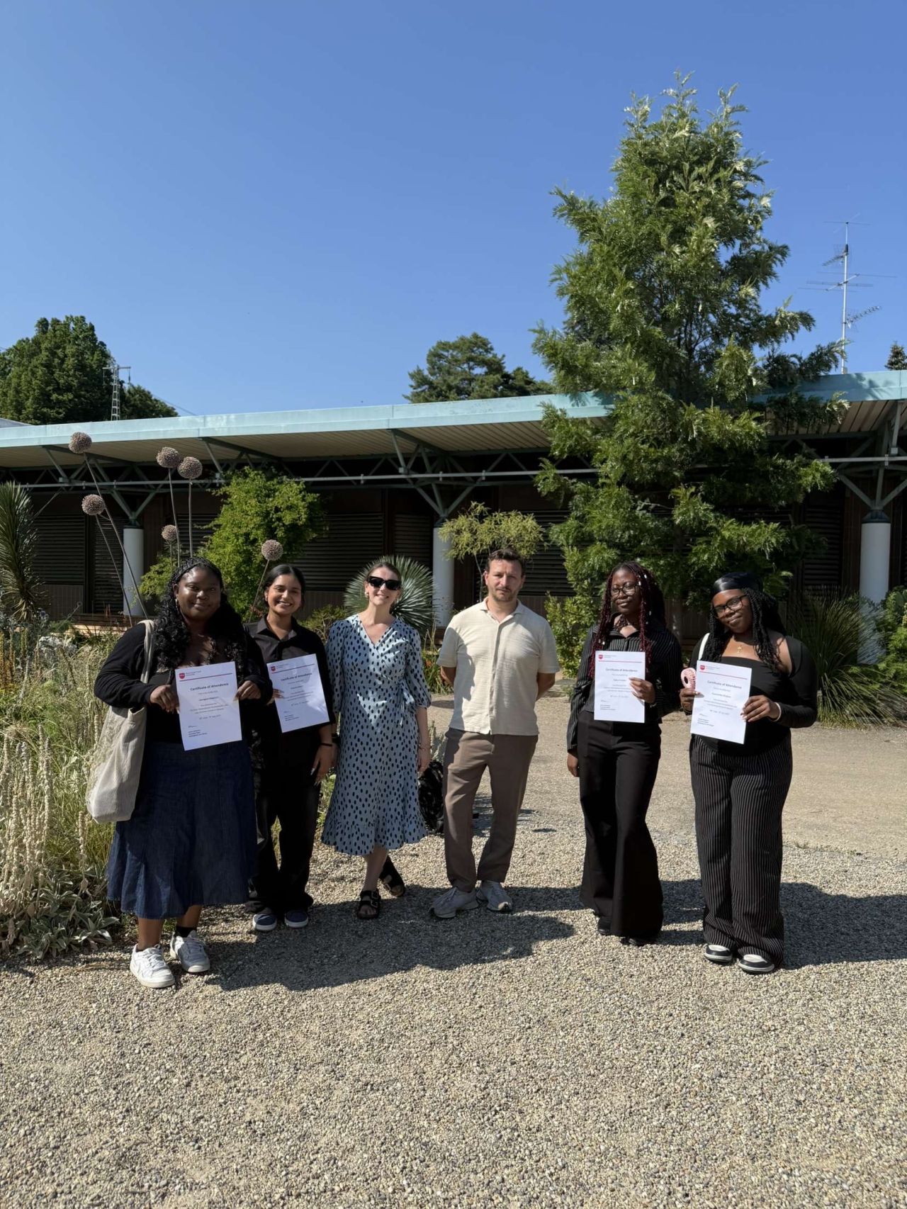 Students and their professor holding diploma