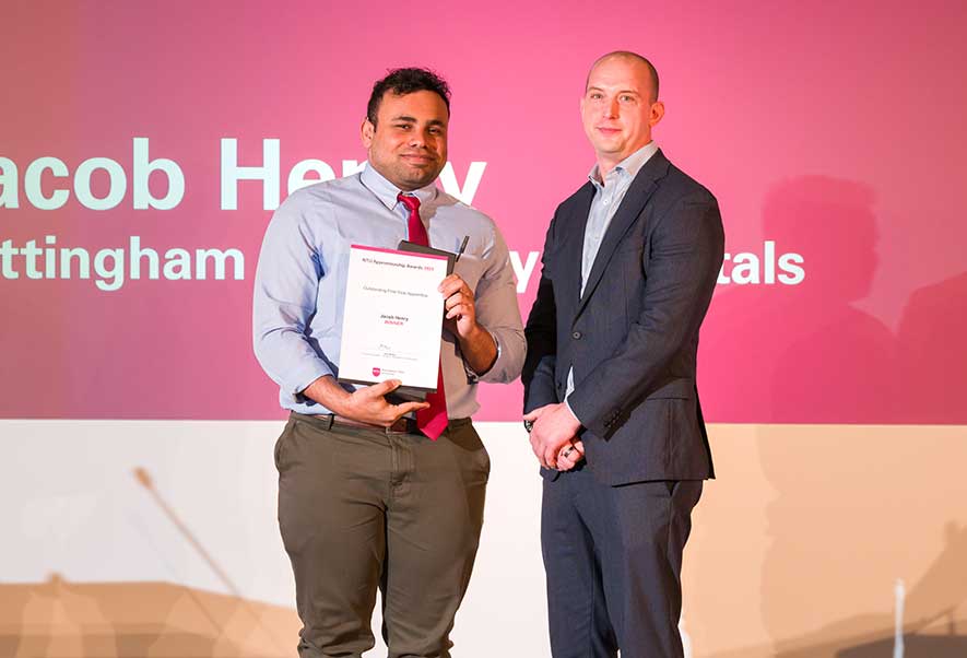 Jacob Henry collecting his apprenticeship award on stage at NTU