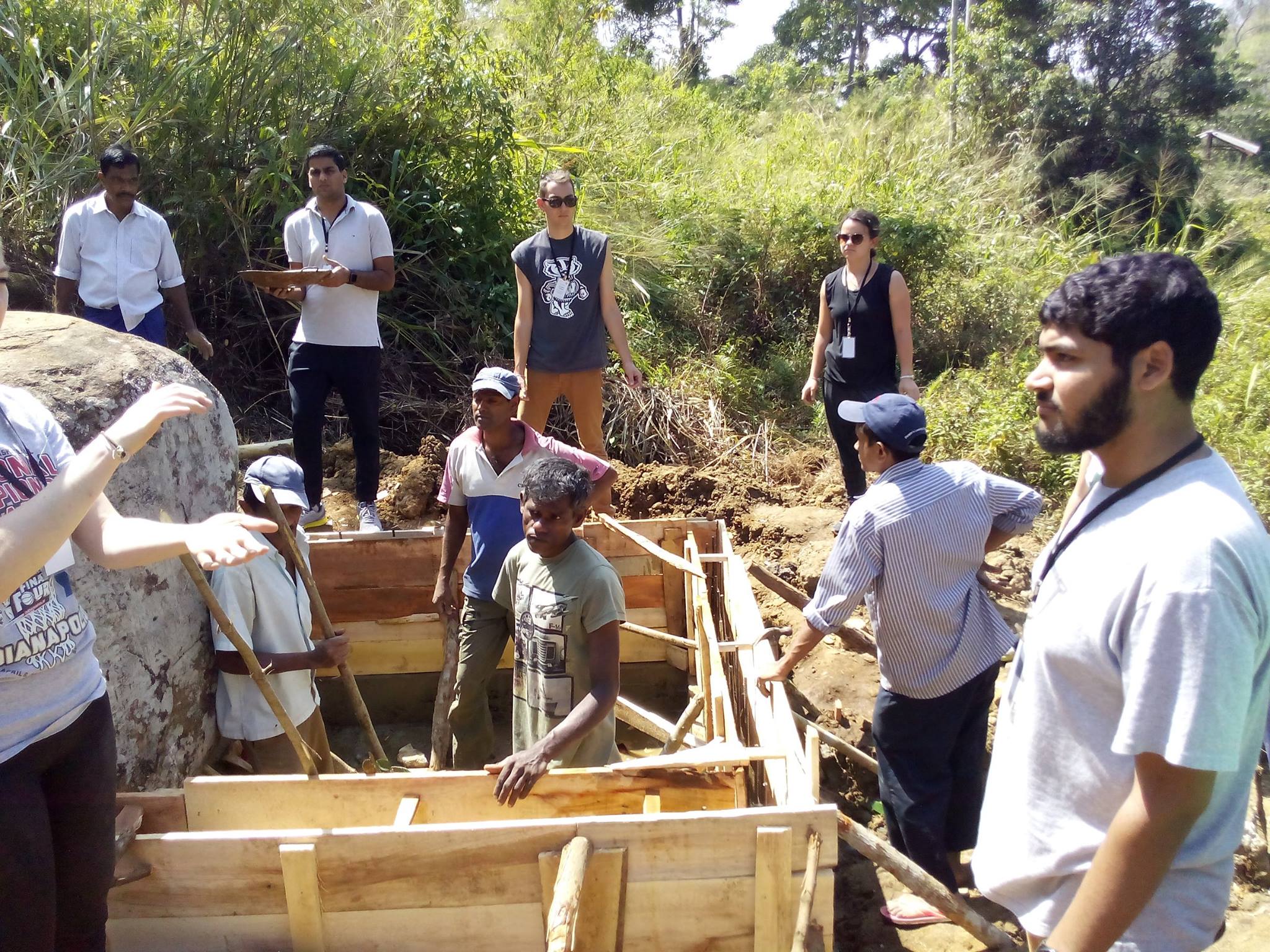 Members of Hippola's community working on the new well