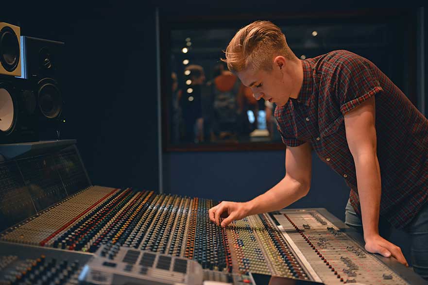 Student working on mixing desk image