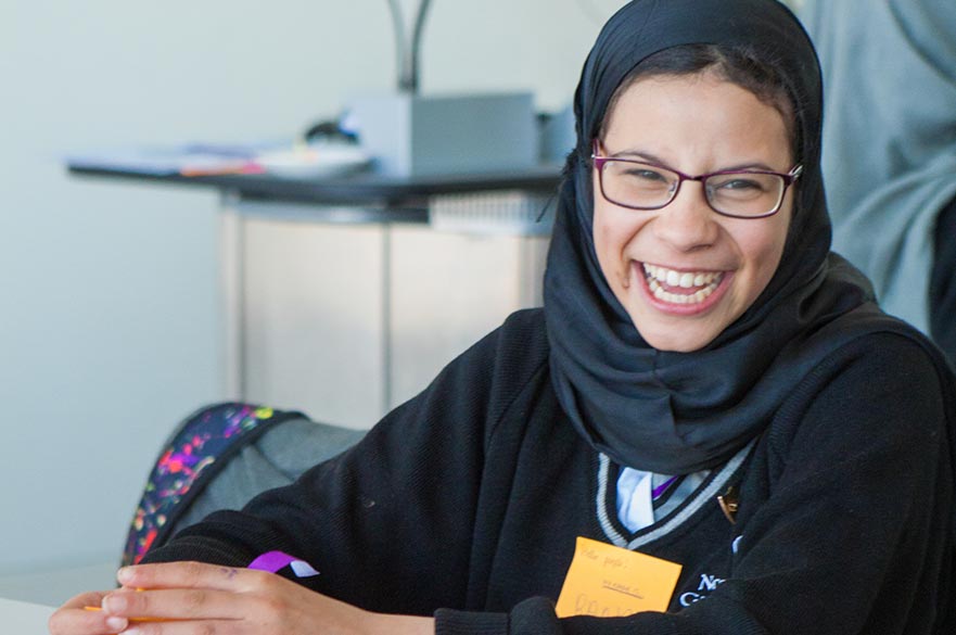 student in glasses laughing