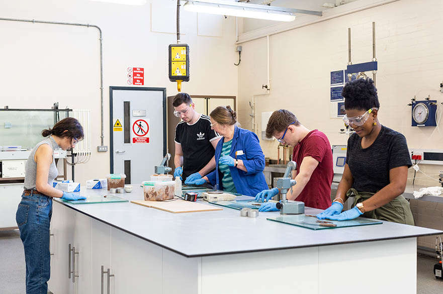 Technical staff member running a workshop with students in the geotechnical and soils laboratory, Maudslay workshops