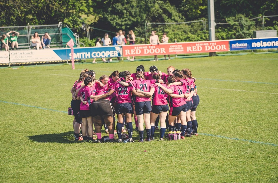 NTU women's rugby team in a huddle