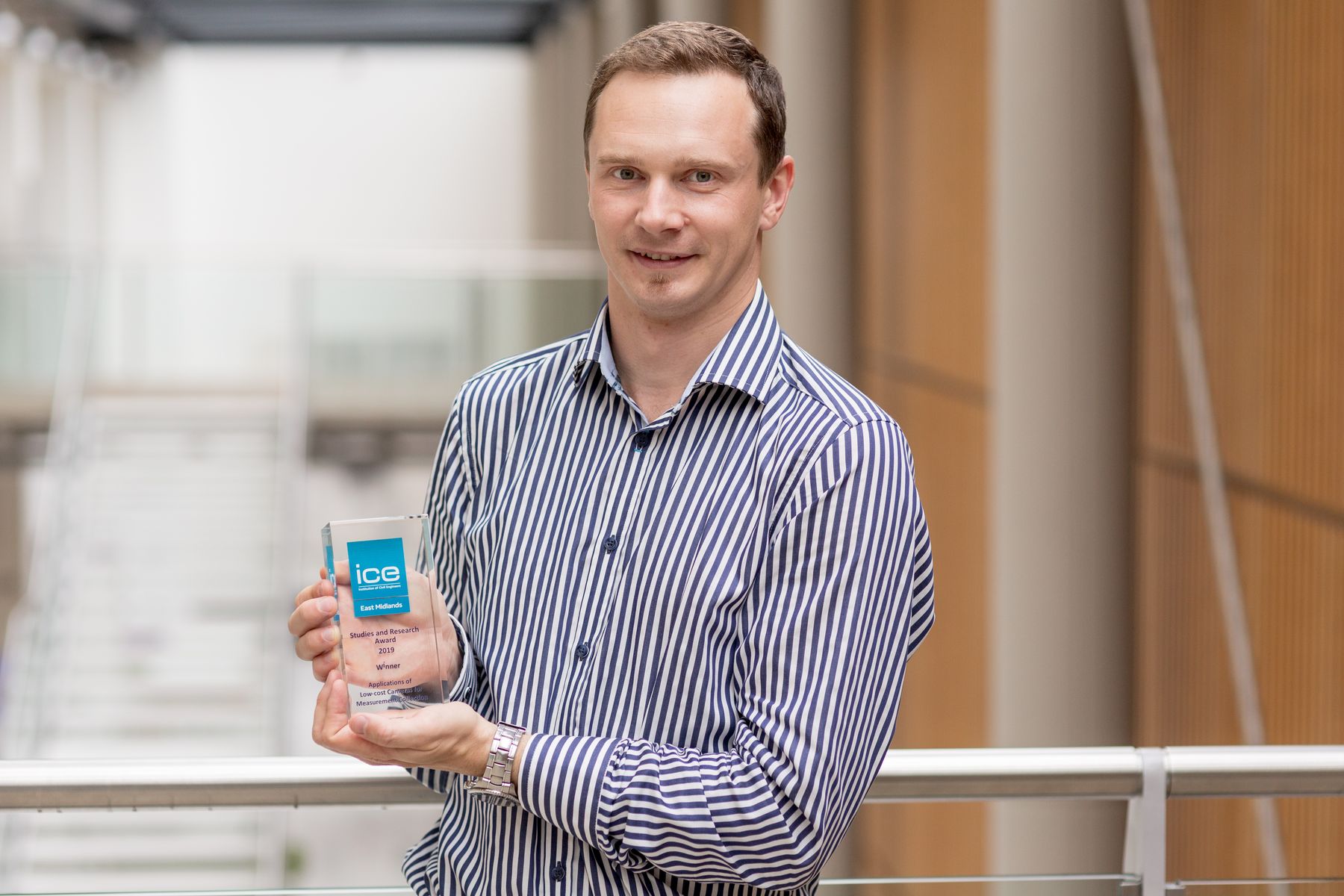 Professor Rolands holding ICE award