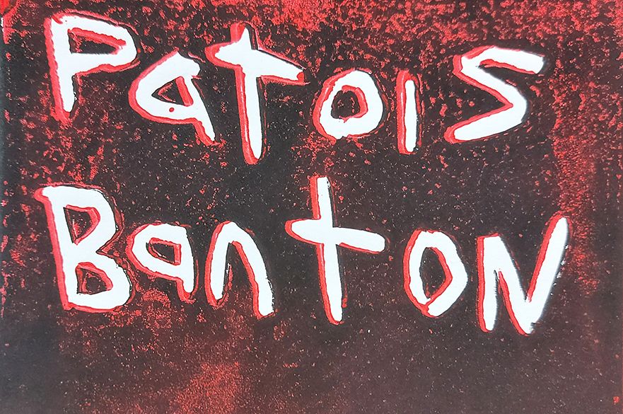 A red and black screenprint with white handwritten text saying 'Patois Banton'