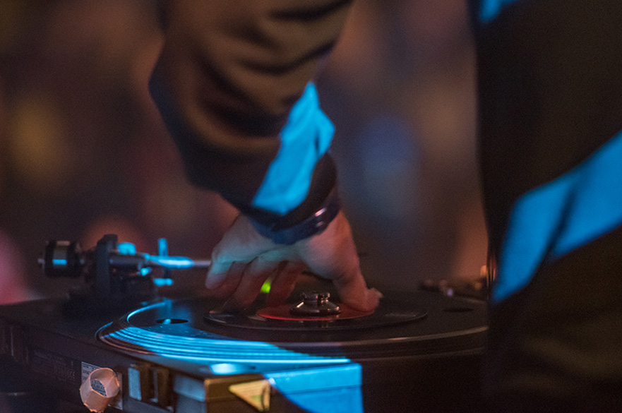A hand using a DJ mixing board