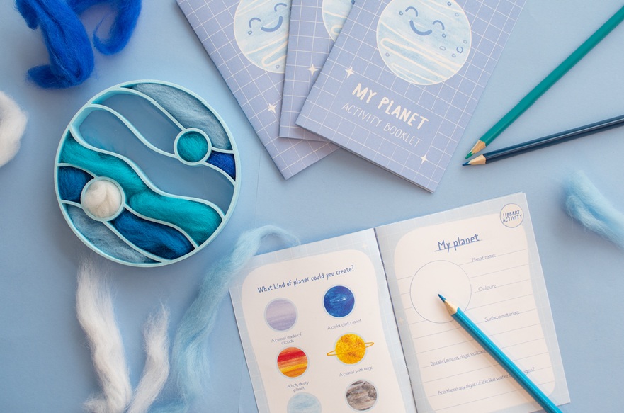 Some cards with pictures and names of planets on and a box of materials.