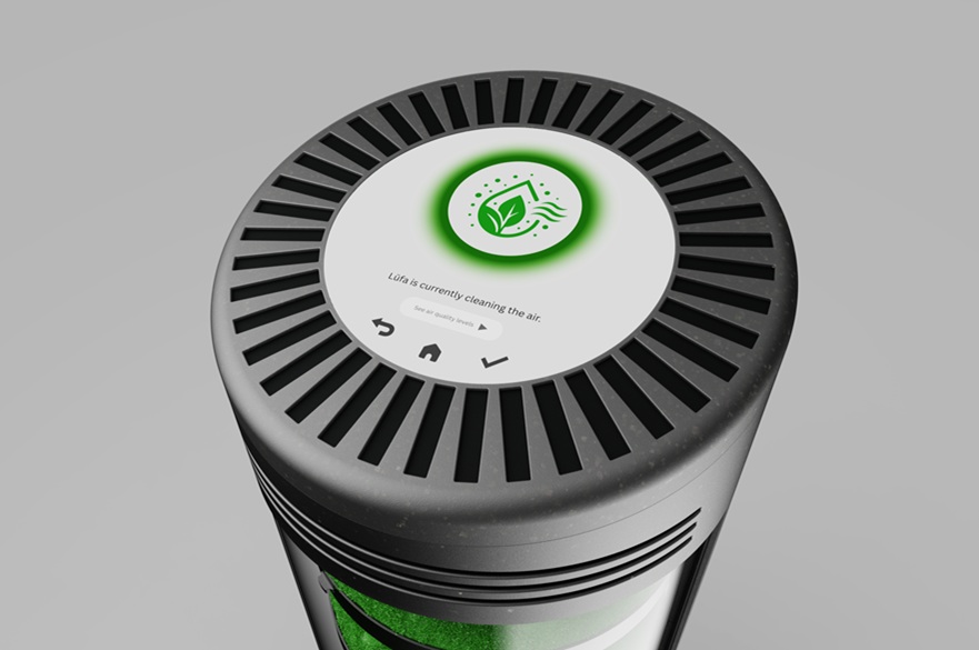 A view of the top of a cylindrical air purification unit. There is a circle of narrow vents and a green leaf icon shows that it is in operation. Text display says Lüfa is currently cleaning the air.