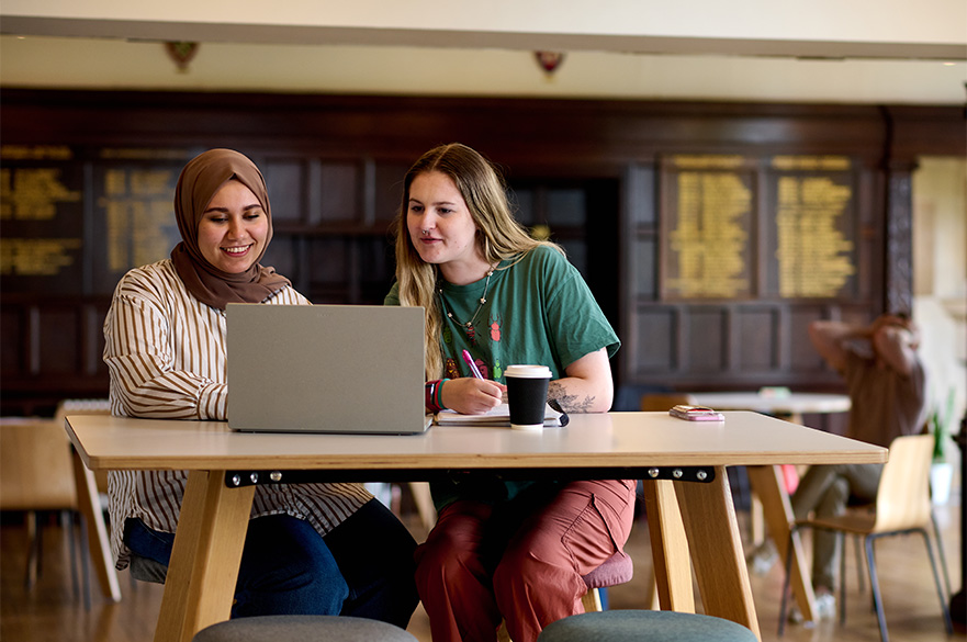 Students working together on a laptop at Brackenhurst campus