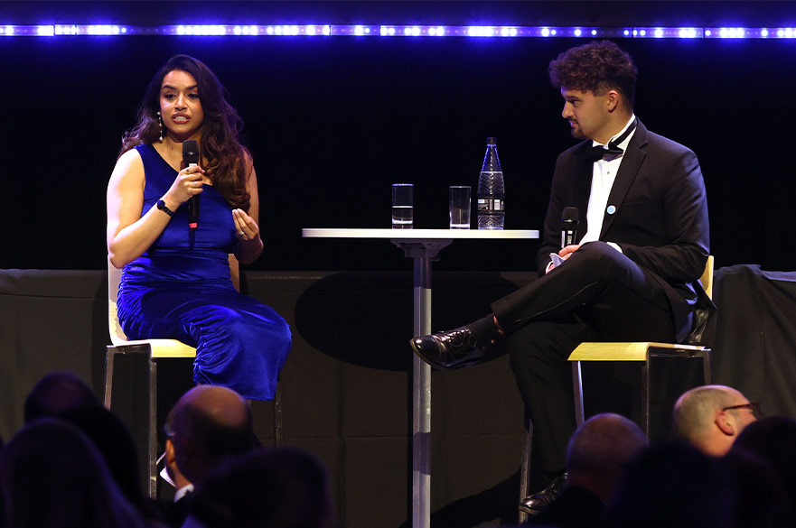 Ross Waldron discussing his award on stage