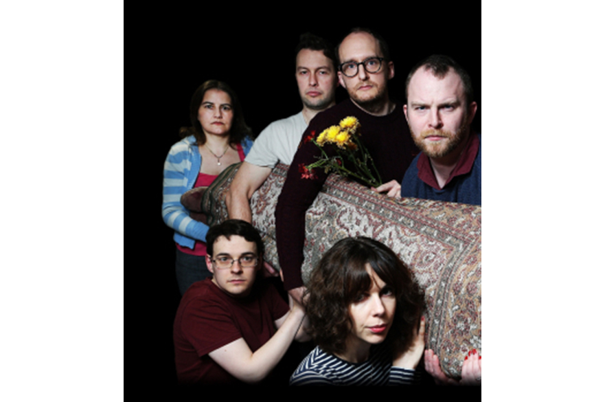 Rhymes Against Humanity holding a rolled up carpet.