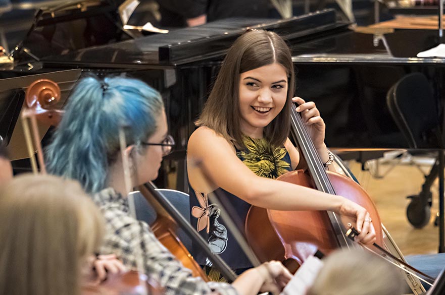 Girl playing cello in concert