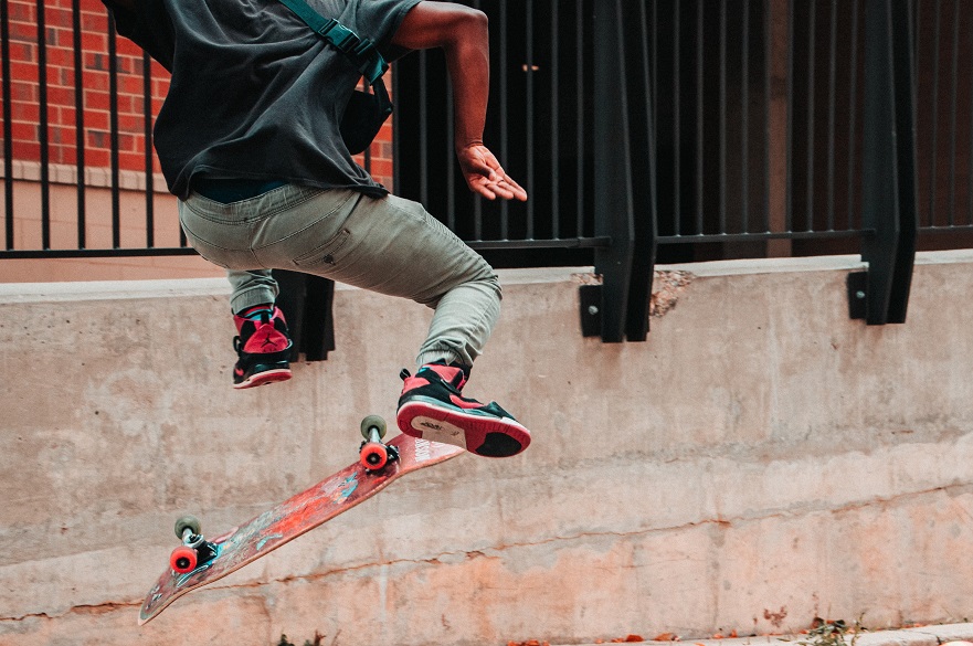 Back of a person skateboarding on the street