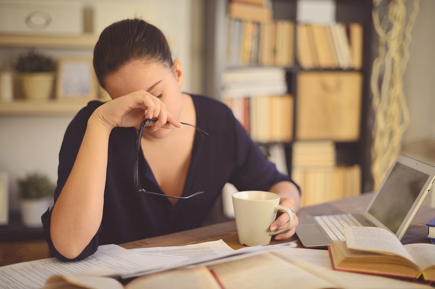 Women looking unwell at her home desk