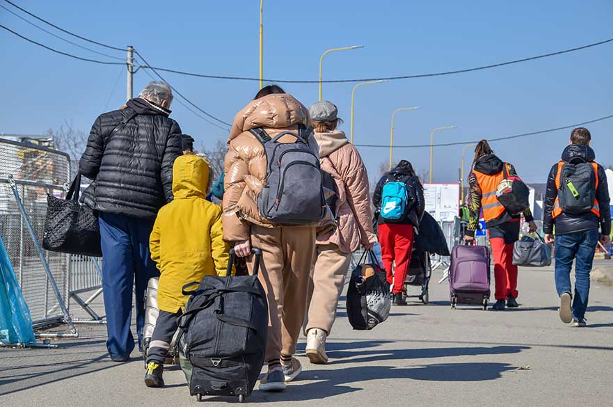 Asylum seekers walking with suitcases