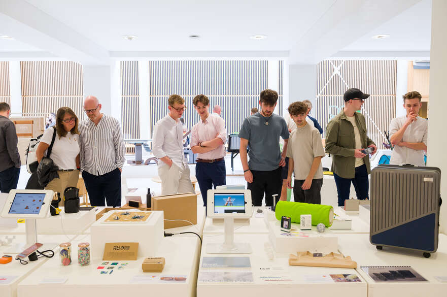 Visitors looking at product design projects at the 2023 Student Showcase
