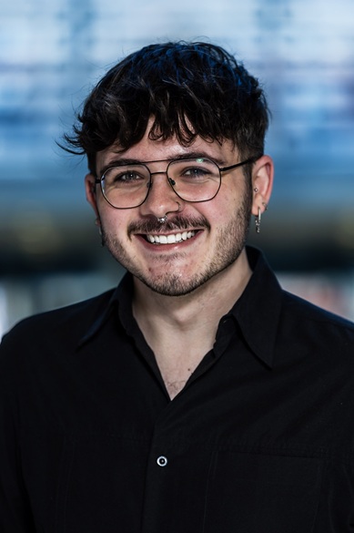 A person posing, smiling, for a photograph.