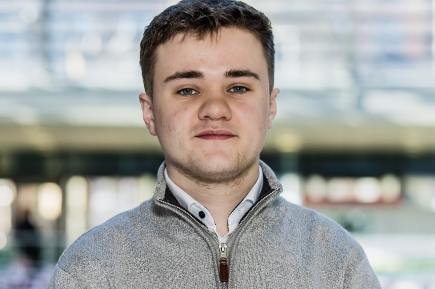 A person posed for a photograph, facing the camera.