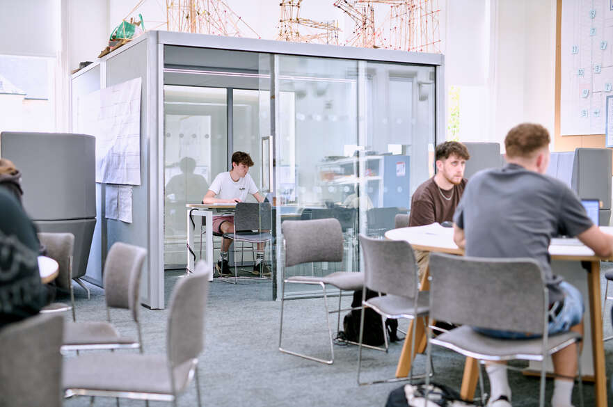 Student working glass cube study space
