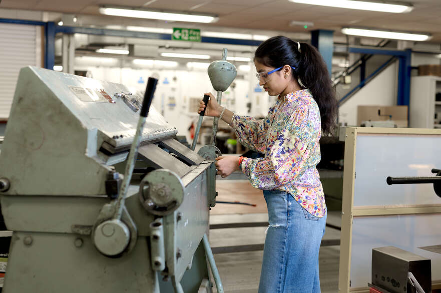 Student stood at metal bending machine