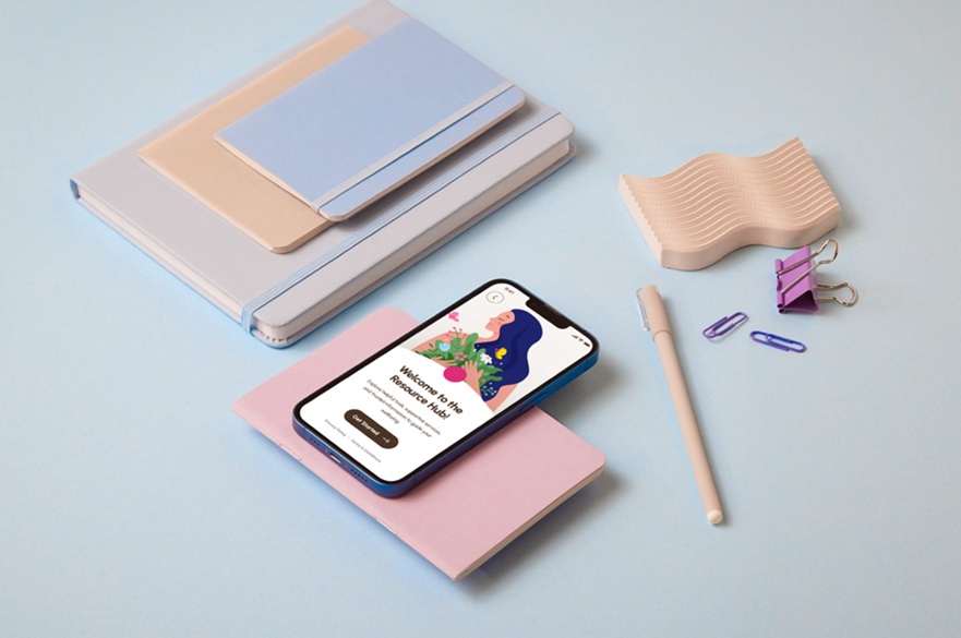 A desk with a mobile phone on it showing a screen within a wellbeing app