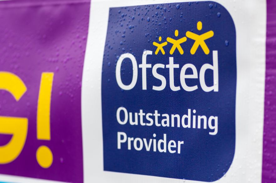 Sign outside a school showing Ofsted outstanding provider