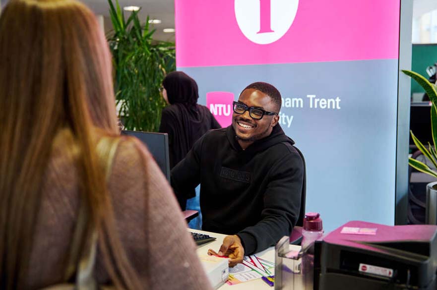 A member of staff sits ready to help at an Ask NTU Hub