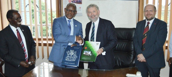 NTU and Makerere staff singing a MoU document