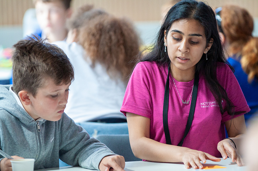 Teacher working on a table with pupil in a classroom