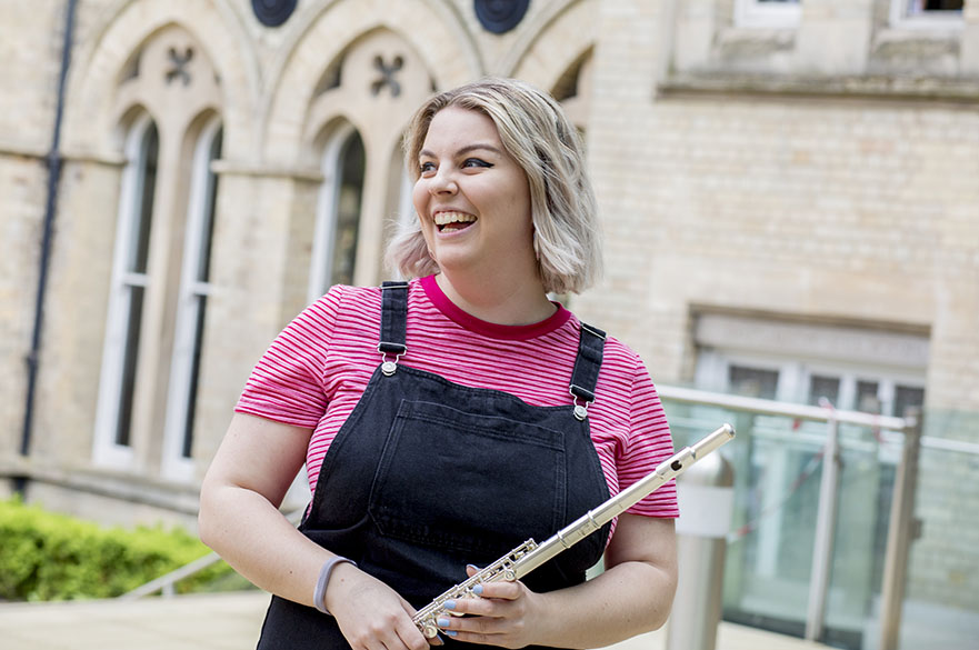 Female student stood with flute.