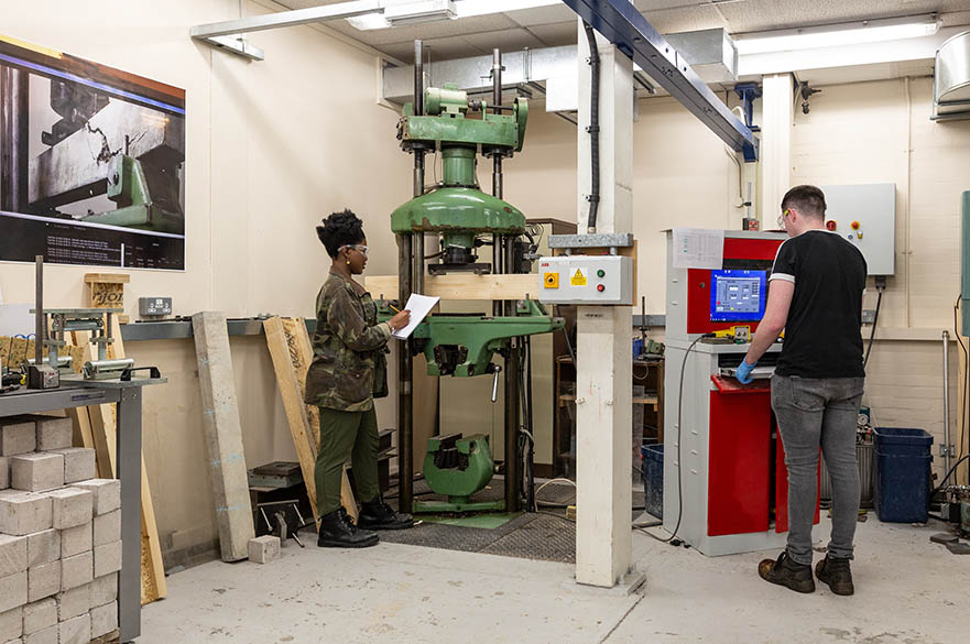 Students working with structural testing machinery in our Maudslay workshops