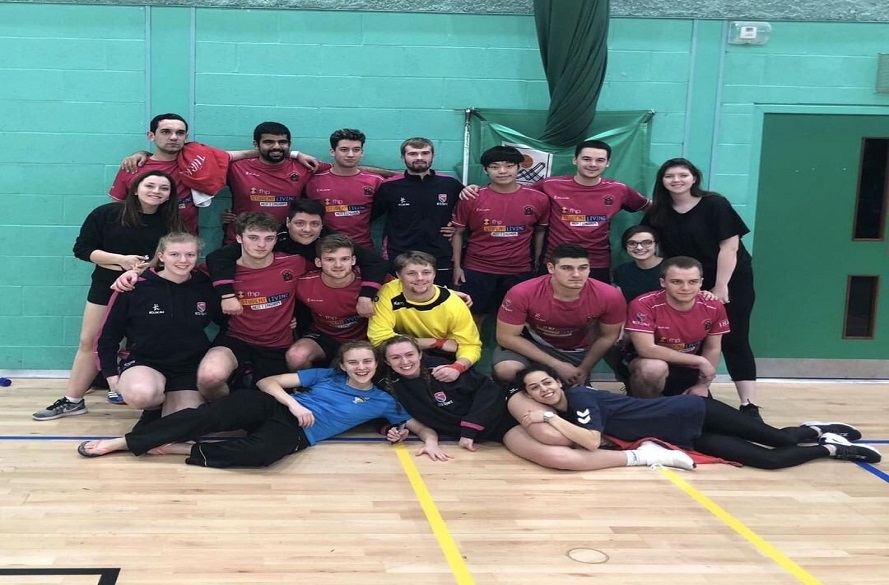 Group photo of the whole NTU handball team smiling