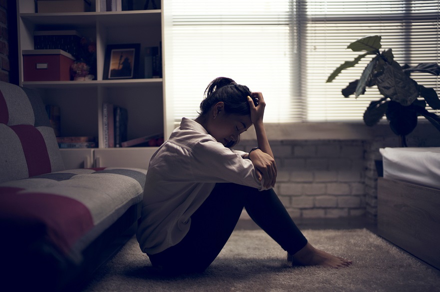 Women in a dark room looking stressed